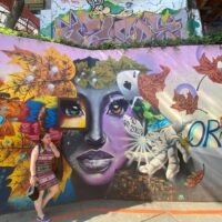 Comuna 13 in San Javier, Medellín, featuring colorful murals, vibrant street life, and a rich history of cultural transformation