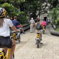 Group of tourists listening to guide in Medellín city center