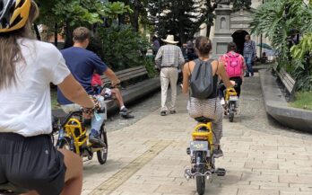 Group of tourists listening to guide in Medellín city center