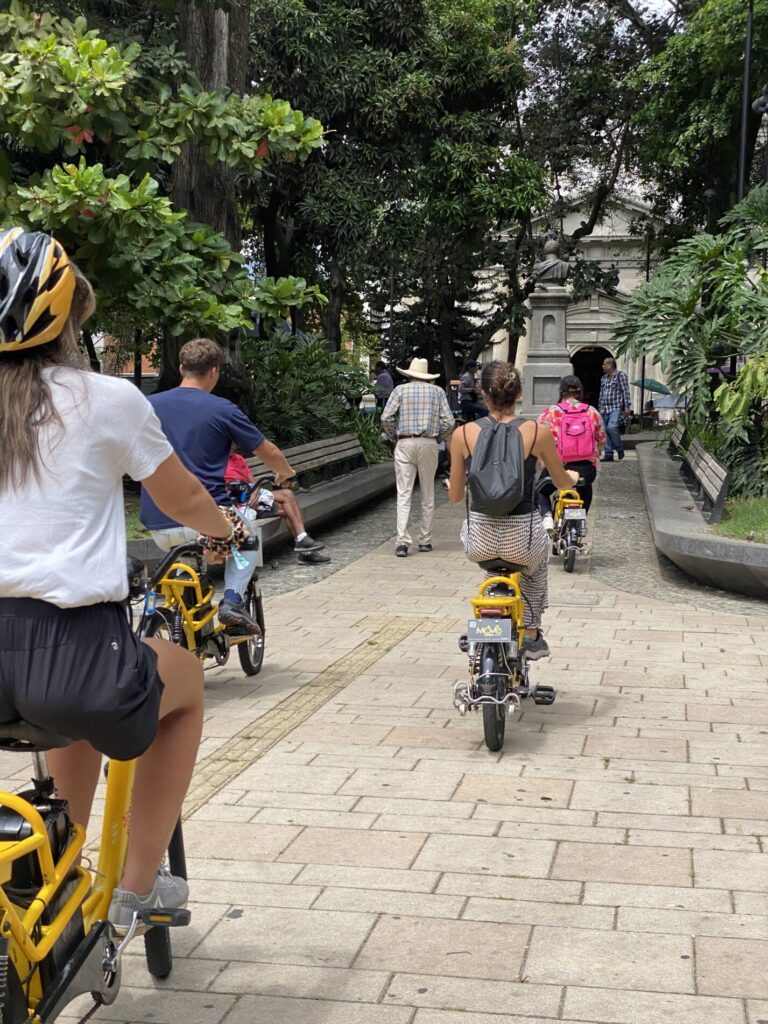 Group of tourists listening to guide in Medellín city center
