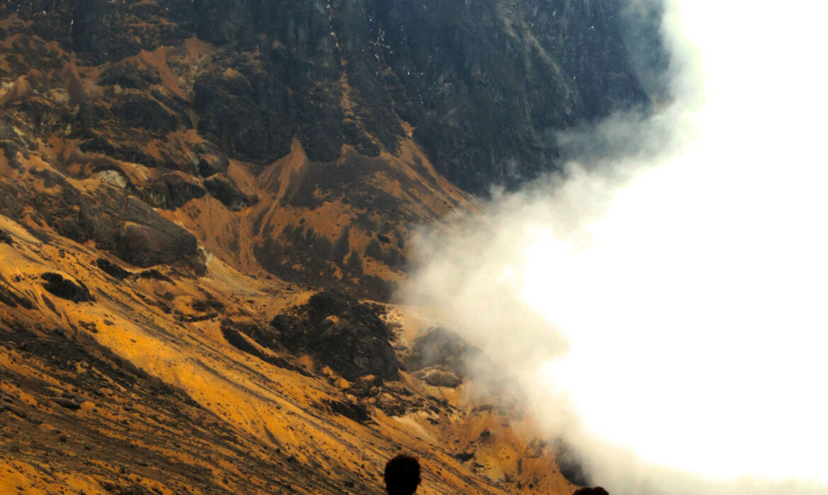 Hiker walking through lush Andean forest on the way to Santa Isabel Summit