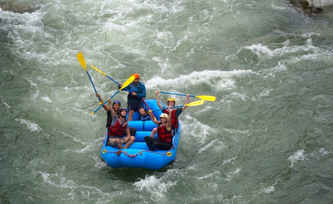 people in raft waving at photograph