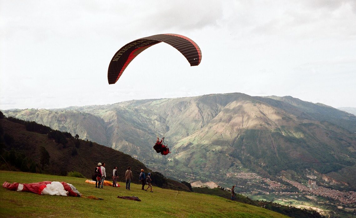 paraglider launching above medellin