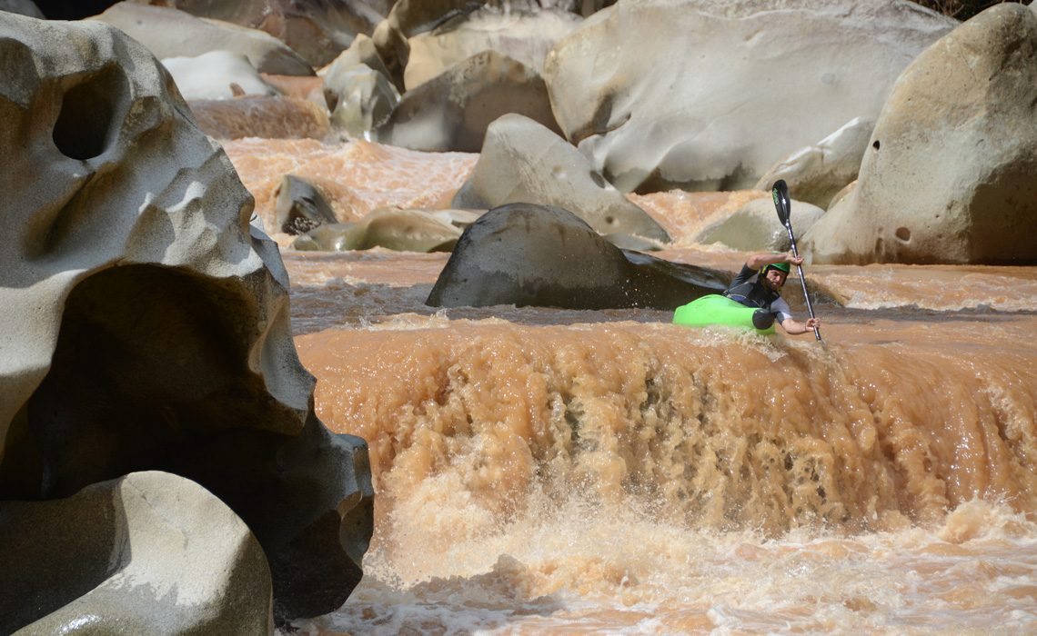 kayaker going over waterfall